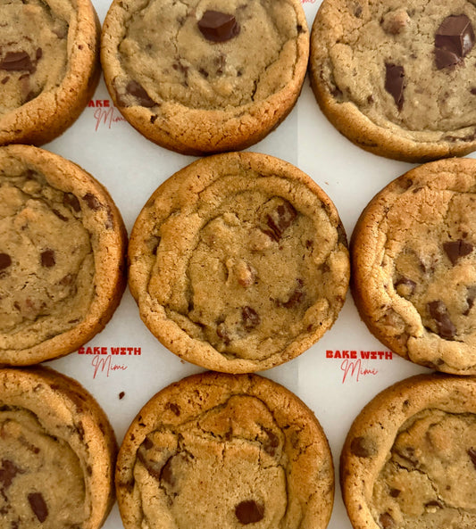 Freshly baked chocolate chip cookies on Bake With Mimi branded parchment paper